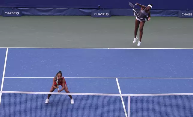 Venus Williams, of the United States, serves with her doubles partner Leylah Fernandez, of Canada, during the third round of the U.S. Open tennis championships, Saturday, Aug. 30, 2025, in New York. (AP Photo/Heather Khalifa)
