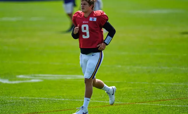 Minnesota Vikings quarterback J.J. McCarthy (9) takes part in drills during a joint NFL football training camp with the New England Patriots, Wednesday, Aug. 13, 2025, in Eagan, Minn. (AP Photo/Abbie Parr)