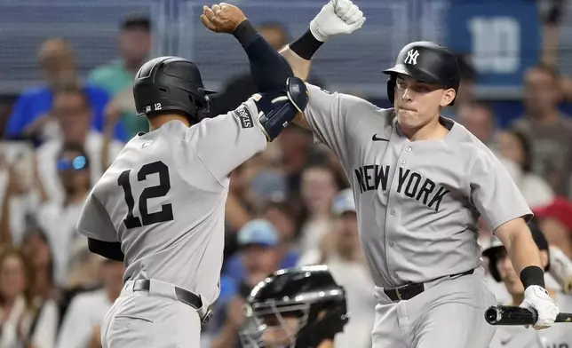 New York Yankees' Trent Grisham (12) celebrates with on deck batter Ben Rice after hitting a home run in the first inning of a baseball game against the Miami Marlins, Sunday, Aug. 3, 2025, in Miami. (AP Photo/Rebecca Blackwell)