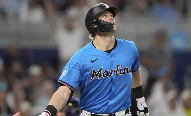 Miami Marlins' Kyle Stowers watches his ball after hitting a three-run homer in the fourth inning of a baseball game against the New York Yankees, Sunday, Aug. 3, 2025, in Miami. (AP Photo/Rebecca Blackwell)