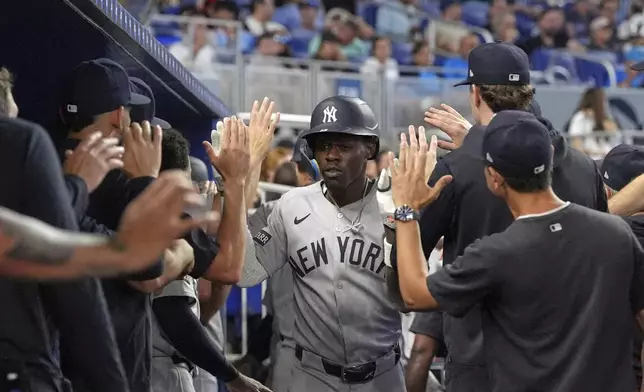 New York Yankees' Jazz Chisholm Jr., center, celebrates with teammates after hitting a two-run homer in the seveth inning of a baseball game against the Miami Marlins, Sunday, Aug. 3, 2025, in Miami. (AP Photo/Rebecca Blackwell)