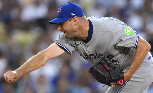 Sweat flies off the face of Toronto Blue Jays starting pitcher Max Scherzer as he throws to the plate during the first inning of a baseball game against the Los Angeles Dodgers, Friday, Aug. 8, 2025, in Los Angeles. (AP Photo/Mark J. Terrill)