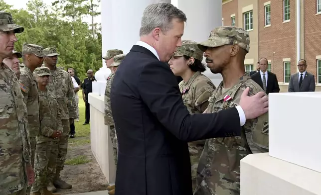 Army Secretary Dan Driscoll comforts Sergeant Aaron Turner after Turner received the Meritorious Service Medal with five other soldiers outside Fort Stewart in Georgia, Thursday, Aug. 6, 2025. (Hyosub Shin /Atlanta Journal-Constitution via AP)