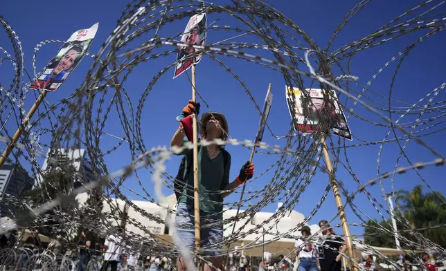 Families of hostages protest, demanding the release from Hamas captivity in the Gaza Strip, at the plaza known as the hostages square in Tel Aviv, Israel, Saturday, Aug. 2, 2025. (AP Photo/Ariel Schalit)