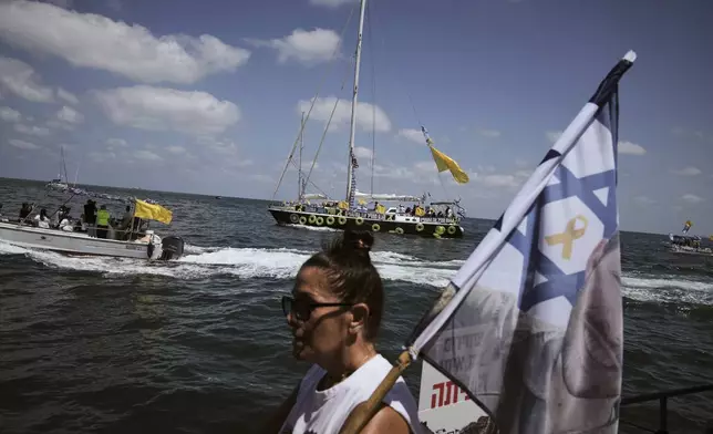 Relatives of Israeli hostages held by Hamas sail along the coast of the Israeli southern city of Ashkelon towards the Gaza Strip, in a protest demanding their release from captivity and calling for an end to the war, Thursday, Aug. 7, 2025. (AP Photo/Leo Correa)