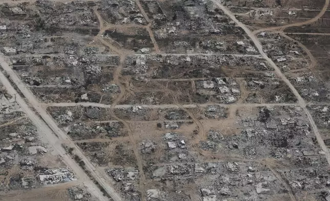 Destroyed buildings in the Gaza Strip are seen from a Jordanian Air Force C-130 plane during an airdrop of humanitarian aid for Palestinians, Thursday, Aug. 7, 2025. (AP Photo/Raad Adayleh)