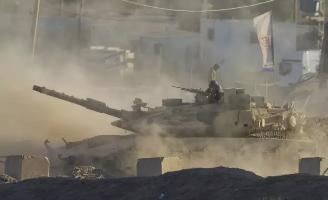 An Israeli tank moves near the border of the Gaza Strip in southern Israel, Wednesday, Aug. 6, 2025. (AP Photo/Ohad Zwigenberg)