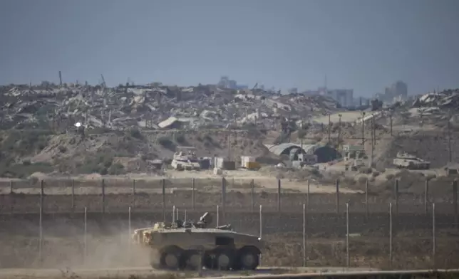 An Israeli army APC moves along the border of the Gaza Strip in southern Israel, Wednesday, Aug. 6, 2025. (AP Photo/Ohad Zwigenberg)