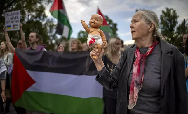 People attend a demonstration against the war in the Gaza Strip, in Vilnius, Lithuania, Monday, Aug. 4, 2025. (AP Photo/Mindaugas Kulbis)