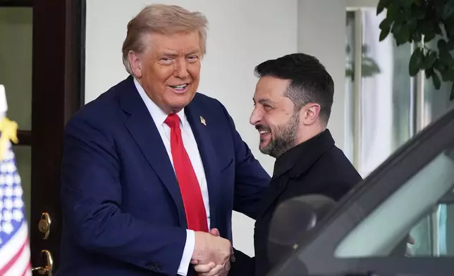 President Donald Trump, left, greets Ukraine's President Volodymyr Zelenskyy as he arrives at the White House, Monday, Aug. 18, 2025, in Washington. (AP Photo/Alex Brandon)