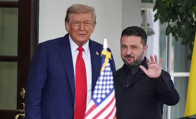 President Donald Trump, left, greets Ukraine's President Volodymyr Zelenskyy as he arrives at the White House, Monday, Aug. 18, 2025, in Washington. (AP Photo/Alex Brandon)