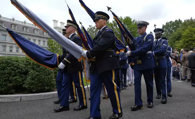 A military honor guard with flags arrives before President Donald Trump greets Ukraine's President Volodymyr Zelenskyy at the White House, Monday, Aug. 18, 2025, in Washington. (AP Photo/Julia Demaree Nikhinson)