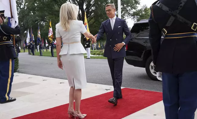 Monica Crowley, White House chief of protocol, left, greets Finland's President Alexander Stubb upon arriving to meet with President Donald Trump and Ukraine's President Volodymyr Zelenskyy, Monday, Aug. 18, 2025, at the South Portico of the White House in Washington. (AP Photo/Jacquelyn Martin)