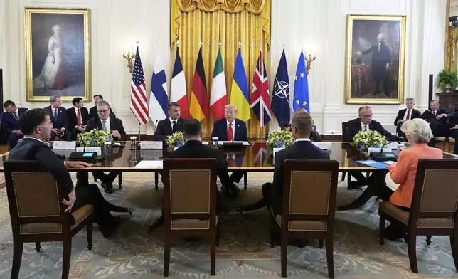President Donald Trump, seated center, speaks during a meeting with British Prime Minister Keir Starmer, seated from left, France's President Emmanuel Macron and Germany's Chancellor Friedrich Merz in the East Room of the White House, Monday, Aug. 18, 2025, in Washington. (AP Photo/Alex Brandon)