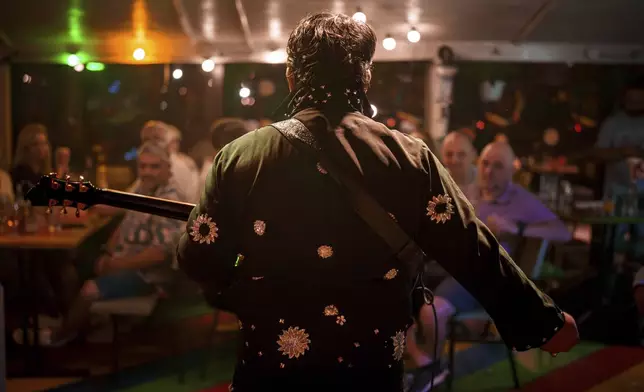 Tudor Lakatos, who goes by the stage name Elvis Rromano, performs with the Taraful Frunzelor band, at the Terasa Florilor restaurant, in Bucharest, Romania, Friday, June 20, 2025. (AP Photo/Vadim Ghirda)