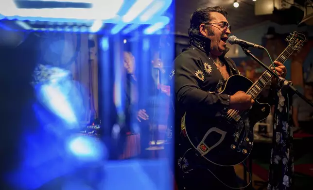 Tudor Lakatos, who goes by the stage name Elvis Rromano, performs at the Terasa Florilor restaurant with the Taraful Frunzelor band, in Bucharest, Romania, Friday, June 20, 2025. (AP Photo/Andreea Alexandru)
