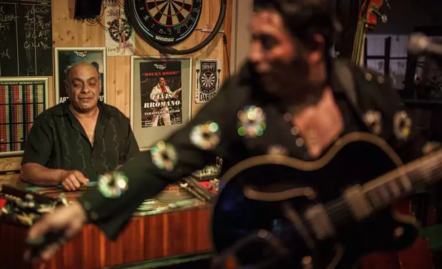 Tudor Lakatos, who goes by the stage name Elvis Rromano, performs at the Terasa Florilor restaurant along with Nicolae Feraru, of the Taraful Frunzelor band, on the cimbalom, in Bucharest, Romania, Friday, June 20, 2025. (AP Photo/Vadim Ghirda)