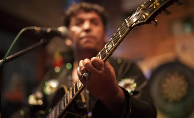 Tudor Lakatos, who goes by the stage name Elvis Rromano, performs with the Taraful Frunzelor band, at the Terasa Florilor restaurant, in Bucharest, Romania, Friday, June 20, 2025. (AP Photo/Vadim Ghirda)