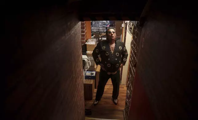 Tudor Lakatos, who goes by the stage name Elvis Rromano, prepares before a performance at the Terasa Florilor restaurant in Bucharest, Romania, Friday, June 20, 2025. (AP Photo/Vadim Ghirda)