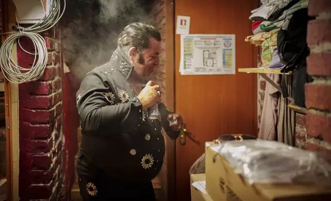 Tudor Lakatos, who goes by the stage name Elvis Rromano, prepares before a performance at the Terasa Florilor restaurant in Bucharest, Romania, Friday, June 20, 2025. (AP Photo/Vadim Ghirda)