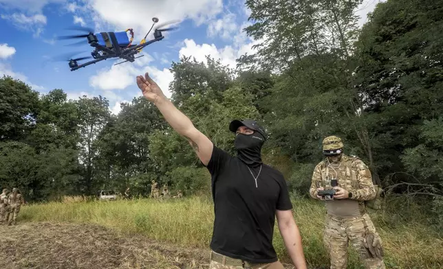 A Ukrainian serviceman of 57th motorised brigade controls an FPV drone at the frontline in Kharkiv region, Ukraine Tuesday, Aug. 12, 2025. (AP Photo/Andrii Marienko)