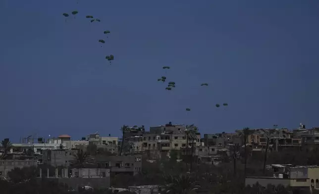 Humanitarian aid is airdropped to Palestinians over Deir al-Balah, central Gaza Strip, Wednesday, Aug. 6, 2025. (AP Photo/Abdel Kareem Hana)