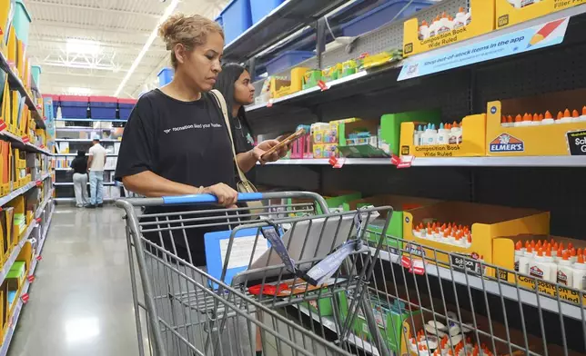 Dora Diaz, left, and her daughter Fernanda Diaz, 14, shops for school supplies at a Walmart in Dallas, Texas, Tuesday, Aug. 12, 2025. (AP Photo/LM Otero)
