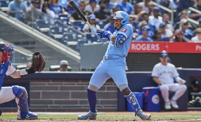 Kansas City Royals second base Jonathan India (6) reacts after being hit by a pitch from Toronto Blue Jays pitcher Max Scherzer (31) during third inning MLB baseball action in Toronto, on Saturday, Aug. 2, 2025. (Sammy Kogan/The Canadian Press via AP)