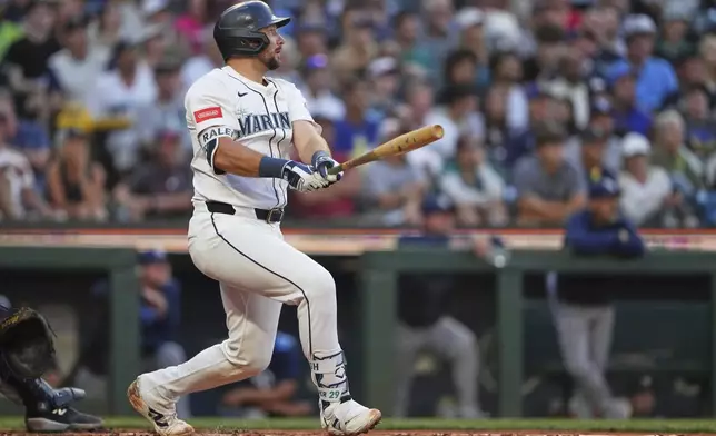 Seattle Mariners' Cal Raleigh follows through on a three-run home run against the Tampa Bay Rays during the third inning of a baseball game Saturday, Aug. 9, 2025, in Seattle. (AP Photo/Lindsey Wasson)