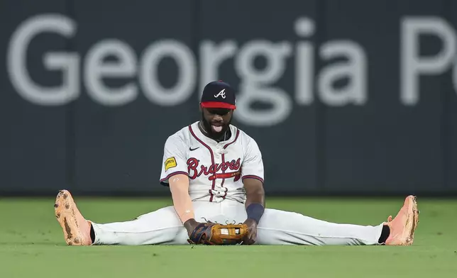 Atlanta Braves outfielder Michael Harris II reacts after making a sliding catch in the ninth inning of a baseball game against the Chicago White Sox, Tuesday, Aug. 19, 2025, in Atlanta. (AP Photo/Colin Hubbard)