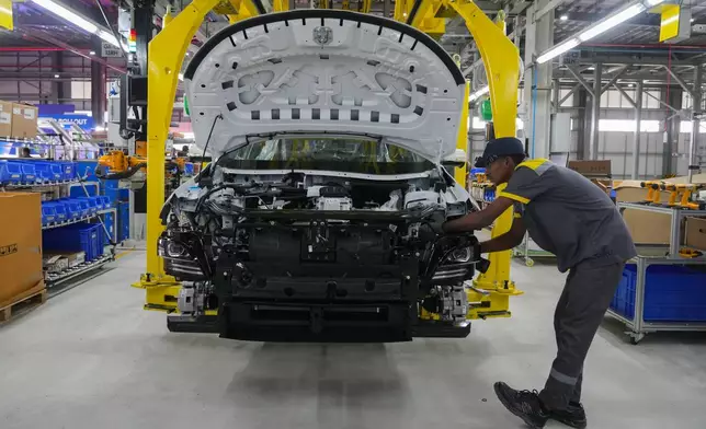 A worker assemble a car at the Vinfast electric vehicle plant in Thoothukudi, in the southern Indian state of Tamil Nadu, Monday, Aug. 4, 2025. (AP Photo/ Rafiq Maqbool)