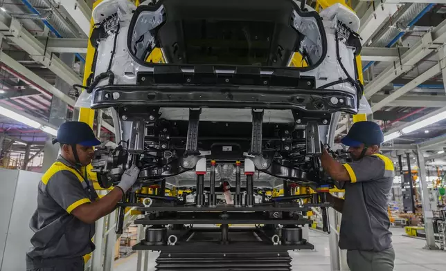 Workers assemble a car at the Vinfast electric vehicle plant in Thoothukudi, in the southern Indian state of Tamil Nadu, Monday, Aug. 4, 2025. (AP Photo/ Rafiq Maqbool)
