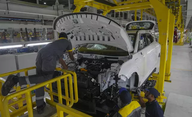 Workers assemble a car at the Vinfast electric vehicle plant in Thoothukudi, in the southern Indian state of Tamil Nadu, Monday, Aug. 4, 2025. (AP Photo/ Rafiq Maqbool)