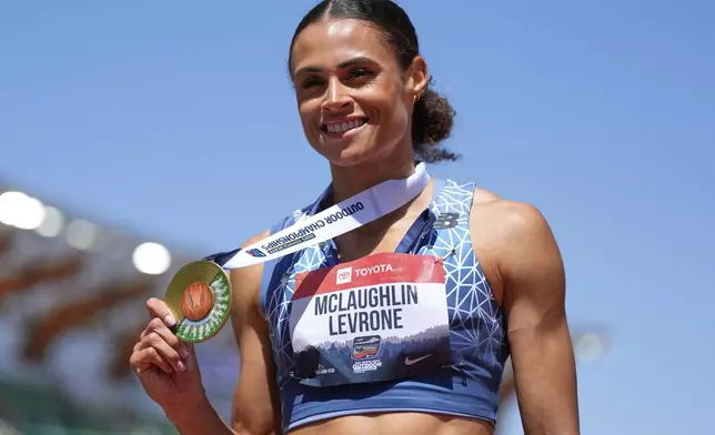 Sydney McLaughlin-Levrone shows her gold medal after winning the women's 400-meter finals during the U.S. Championships athletics meet in Eugene, Ore.,Saturday, Aug. 2, 2025. (AP Photo/Ashley Landis)