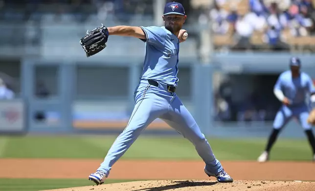 Toronto Blue Jays pitcher Eric Lauer (56) throws a pitch against the Los Angeles Dodgers during the first inning of a baseball game, Sunday, Aug. 10, 2025, in Los Angeles. (AP Photo/Wally Skalij)