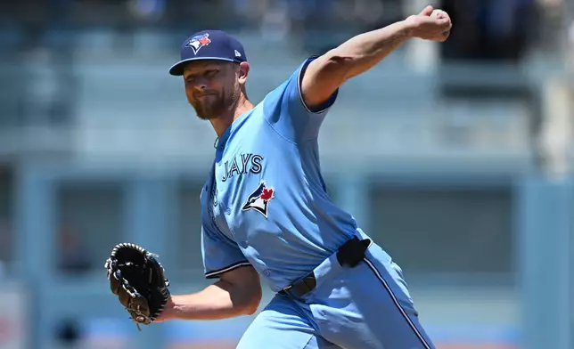 Toronto Blue Jays pitcher Eric Lauer throws a pitch against the Los Angeles Dodgers during the first inning of a baseball game, Sunday, Aug. 10, 2025, in Los Angeles. (AP Photo/Wally Skalij)