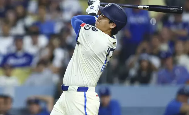 Los Angeles Dodgers designated hitter Shohei Ohtani follows through on a swing during the seventh inning of a baseball game against the Toronto Blue Jays, Saturday, Aug. 9, 2025, in Los Angeles. (AP Photo/Jessie Alcheh)