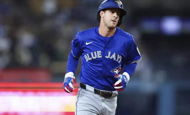 Toronto Blue Jays' Ernie Clement runs the bases after hitting a home run during the eighth inning of a baseball game against the Los Angeles Dodgers, Saturday, Aug. 9, 2025, in Los Angeles. (AP Photo/Jessie Alcheh)