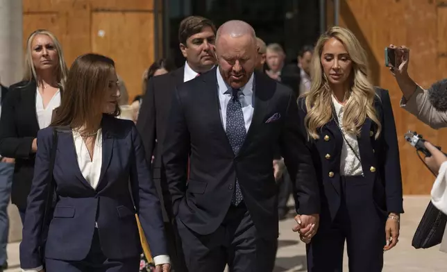 Mathew Bowyer, center, who pled guilty a year ago to running an illegal gambling business, money laundering and filing a false tax return, leaves federal court, Friday, Aug. 29, 2025, in Santa Ana, Calif., following his sentencing to 12 months and one day in prison. (AP Photo/Jae C. Hong)