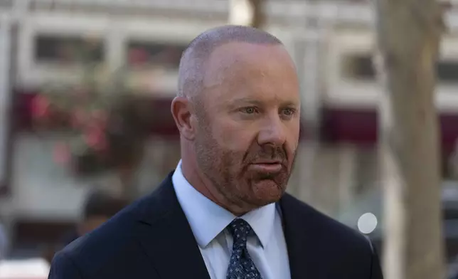 Mathew Bowyer, who pled guilty a year ago to running an illegal gambling business, money laundering and filing a false tax return, talks to his attorney outside federal court, Friday, Aug. 29, 2025, in Santa Ana, Calif., following his sentencing to 12 months and one day in prison, (AP Photo/Jae C. Hong)
