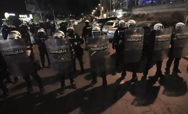 Serbian riot police officers guard an intersection after clearing people blocking a street during an anti-government protest in Belgrade, Serbia, Saturday, Aug. 16, 2025. (AP Photo/Darko Vojinovic)
