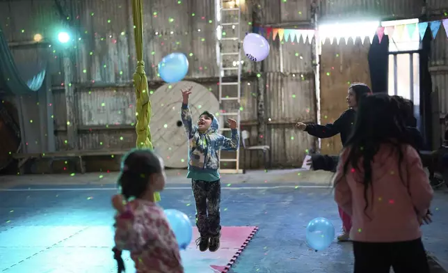 Children play before a circus performance during their mid-year winter break, in Buenos Aires, Argentina, Aug. 2, 2025. (AP Photo/Rodrigo Abd)