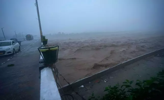 Water level in River Tawi rises closer to a bridge following heavy rains in Jammu, India, Tuesday, Aug 26, 2025.(AP Photo/Channi Anand)