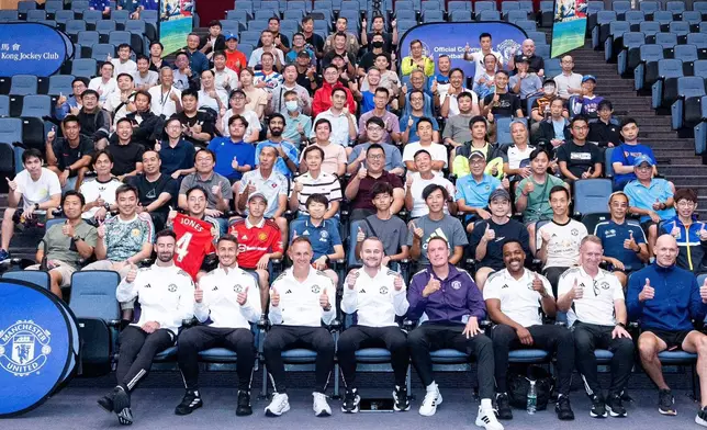 Manchester United legend Phil Jones (4th right, first row) shares football training skills with coaches participating in the JC School Football Development Scheme’s Coaches Workshop.