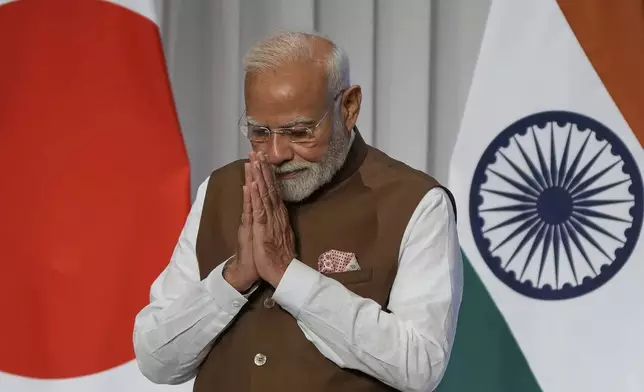 Indian Prime Minister Narendra Modi greets guests after delivering a speech during the Japan India Economic Forum in Tokyo Friday, Aug. 29, 2025. (AP Photo/Eugene Hoshiko)