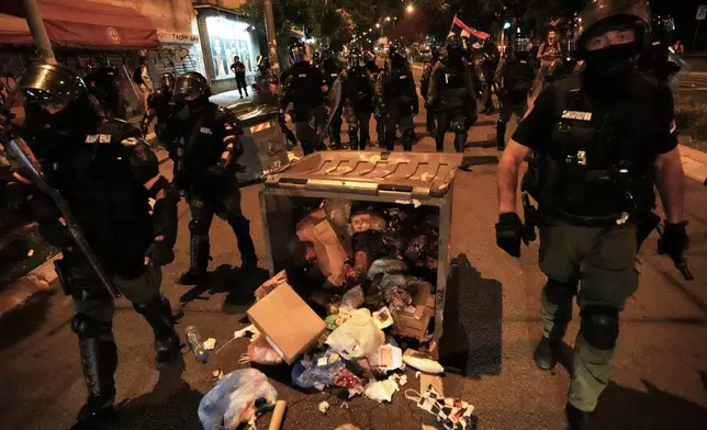 Serbian gendarmerie officers chase protesters during an anti-government protest in Belgrade, Serbia, Monday, Aug. 18, 2025. (AP Photo/Darko Vojinovic)