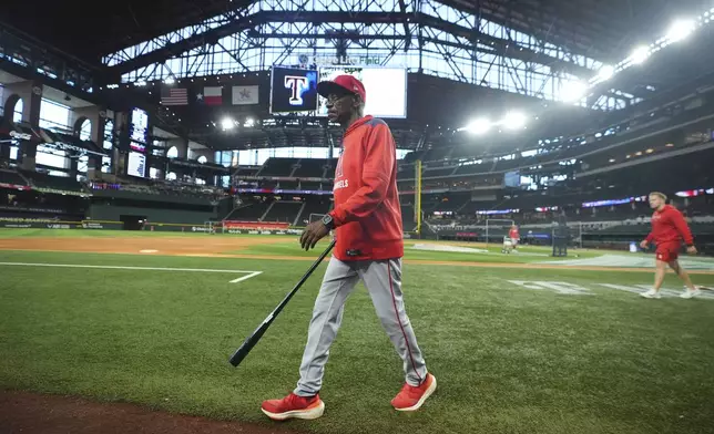 Los Angeles Angels manager Ron Washington walks on the field during batting practice before a baseball game against the Texas Rangers, Monday, Aug. 25, 2025, in Arlington, Texas. (AP Photo/LM Otero)