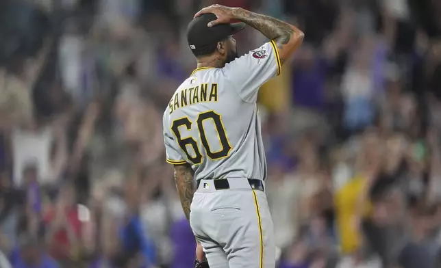 Pittsburgh Pirates relief pitcher Dennis Santana reacts after giving up a two-run, walkoff home run to Colorado Rockies' Brenton Doyle in the ninth inning of a baseball game Friday, Aug. 1, 2025, in Denver. (AP Photo/David Zalubowski)