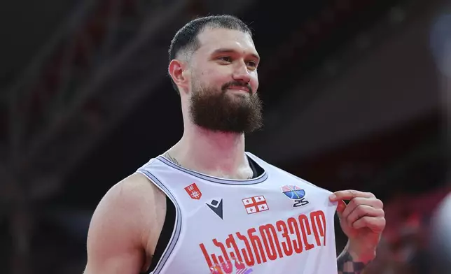 Georgia's Alexander Mamukelashvili celebrates after his team won Spain during the Eurobasket, European Basketball Championship Group C match between Spain and Georgia at the Spyros Kyprianou Arena in Limassol, Cyprus, Thursday, Aug. 28, 2025. (AP Photo/Chara Savvidou)