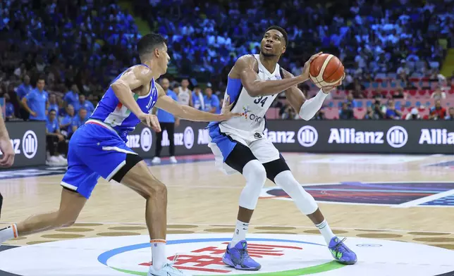 Italy's' Simone Fontecchio defends against Greece's Giannis Antetokounmpo during the Eurobasket, European Basketball Championship Group C match between Greece and Italy at the Spyros Kyprianou Arena in Limassol, Cyprus, Thursday, Aug. 28, 2025. (AP Photo/Chara Savvidou)